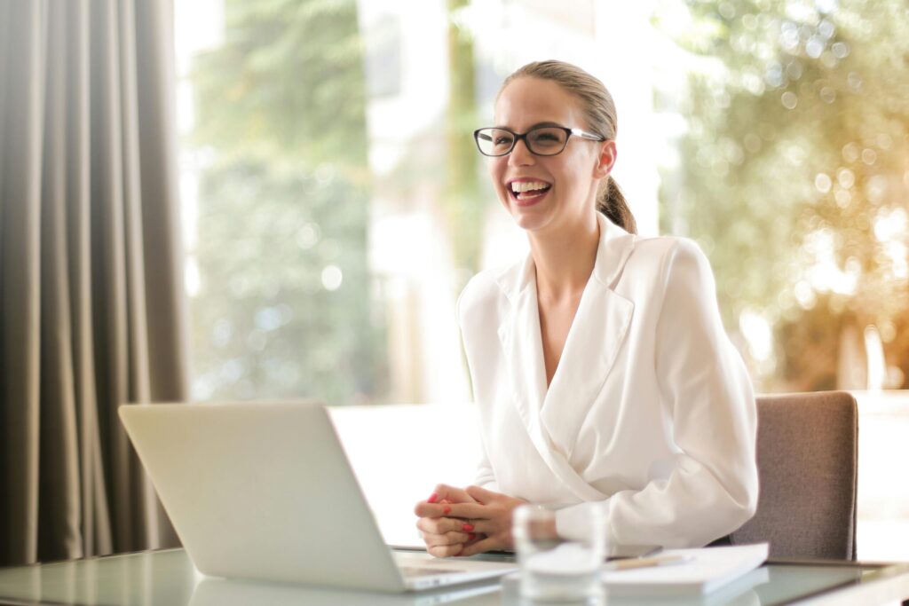 Happy woman smiling with a laptop